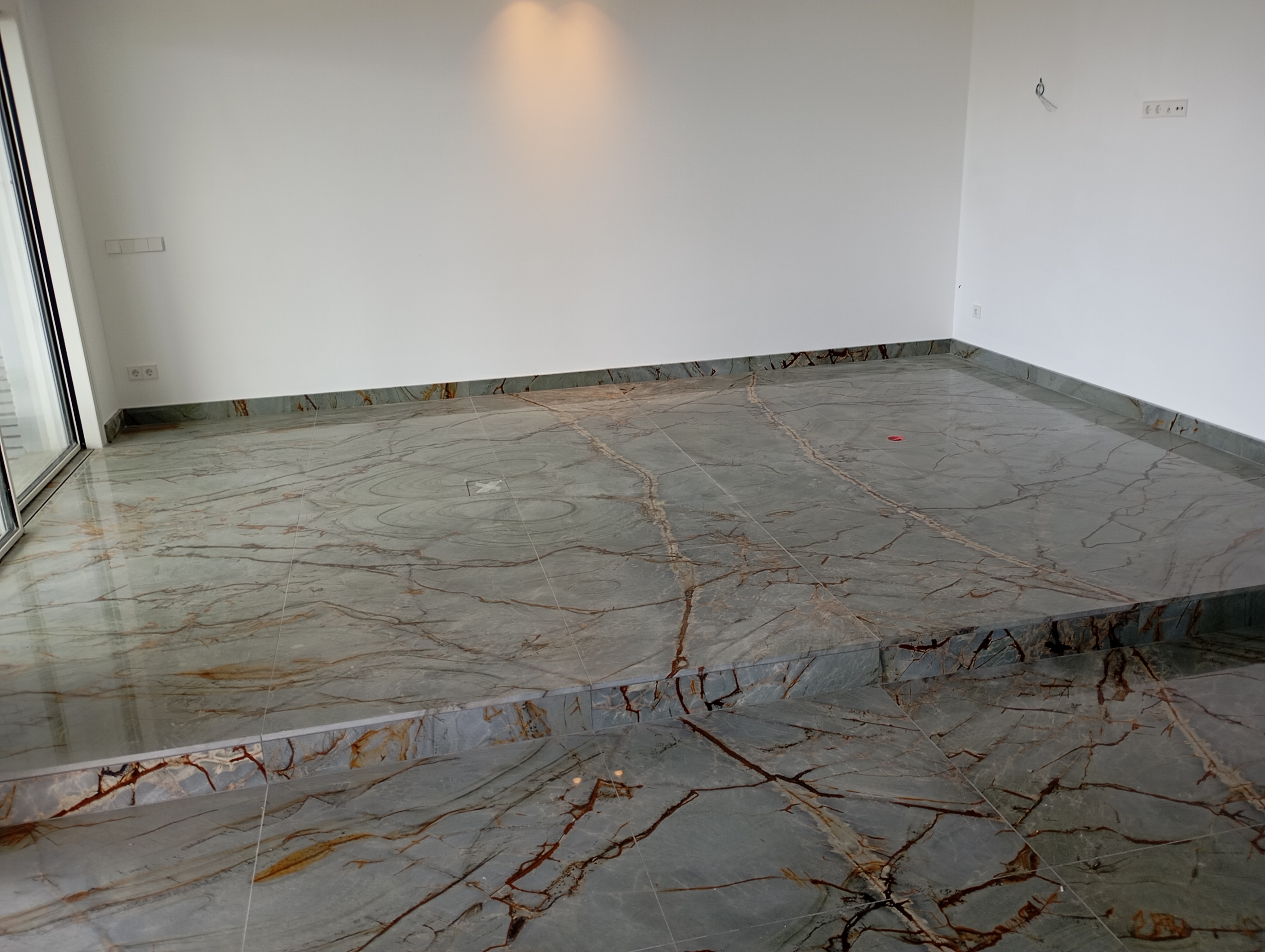 Polished green marble floor with gold veining
